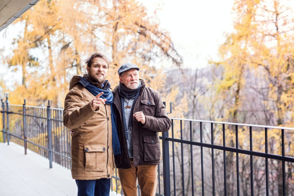 Senior father and his young son on a walk.