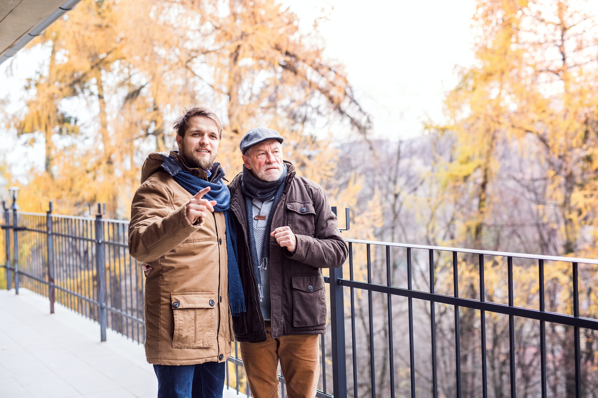 Senior father and his young son on a walk.